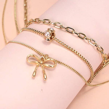 MULTI LAYER PEARL BOW CAHRM NECKLACE