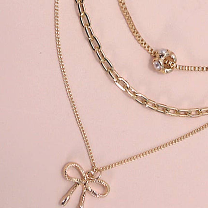 MULTI LAYER PEARL BOW CAHRM NECKLACE
