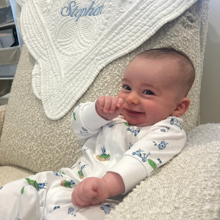Personalized baby quilt — shown with embroidered name in pink