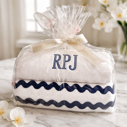 Personalized luxury towel gift set — shown folded and tied with ribbon, embroidery included