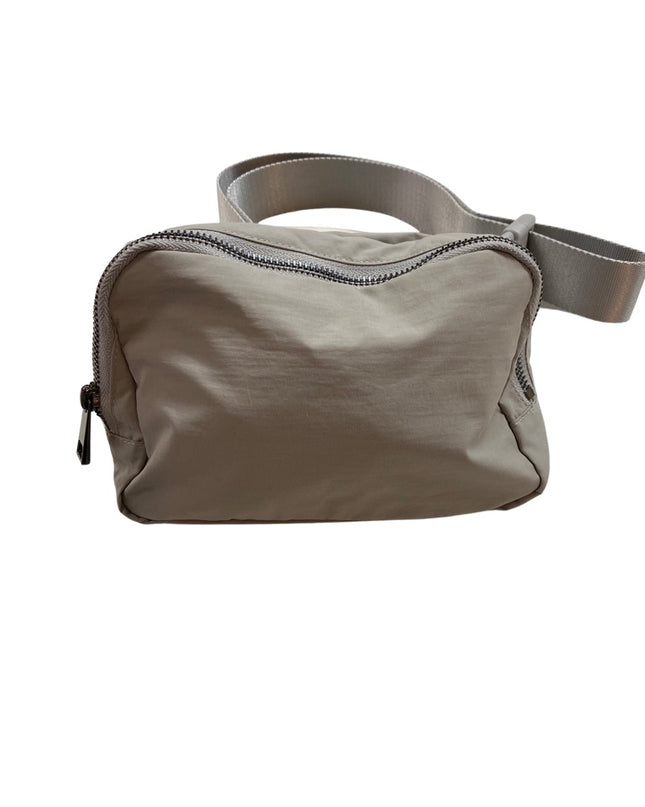 The Keely belt bag — shown open with compartments